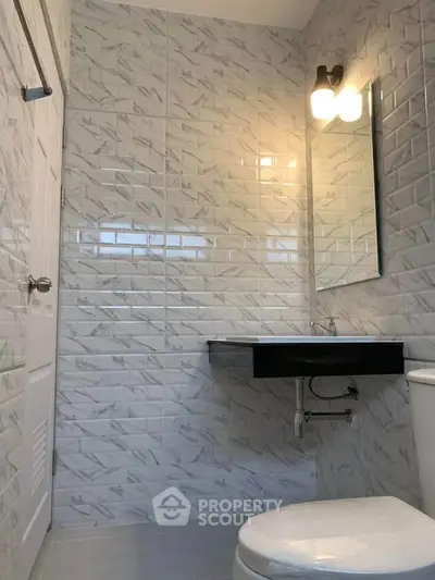 Modern bathroom with sleek tiles and elegant lighting