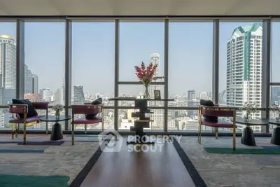 Luxurious high-rise living room with panoramic city views and elegant decor.