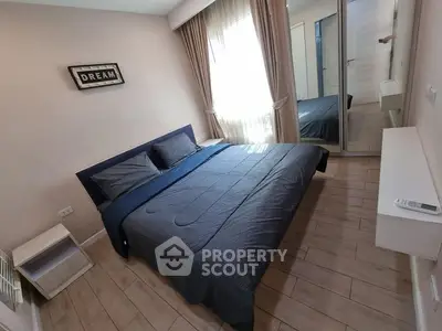 Cozy bedroom with stylish decor and ample natural light