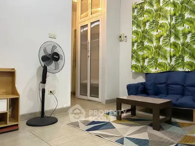 Cozy living room with modern decor and vibrant leaf-patterned curtain