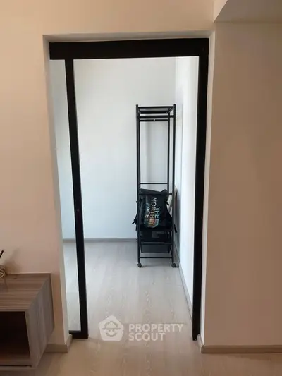 Minimalist storage area with sleek black shelving in modern apartment