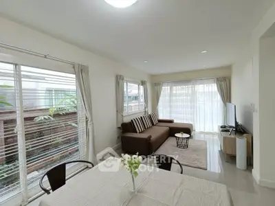 Spacious living room with modern decor and large windows for natural light.