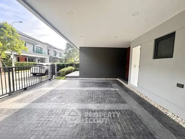 Spacious modern home exterior with sleek design and ample parking space.