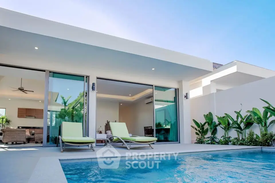 Luxurious modern villa with private pool and spacious patio area.