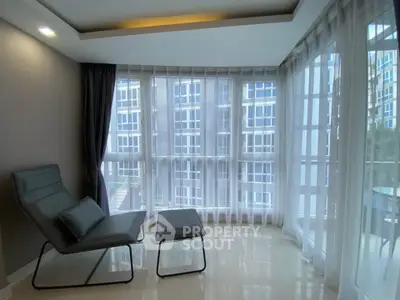 Modern living room with floor-to-ceiling windows and sleek furniture