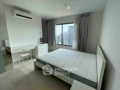 Modern bedroom with city view, featuring minimalist furniture and large window for natural light.