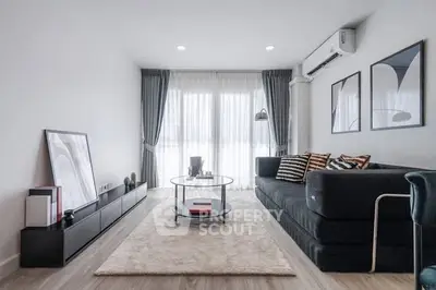 Modern living room with sleek furniture and large windows in a stylish apartment.