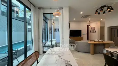 Luxurious modern living room with pool view and elegant marble dining table