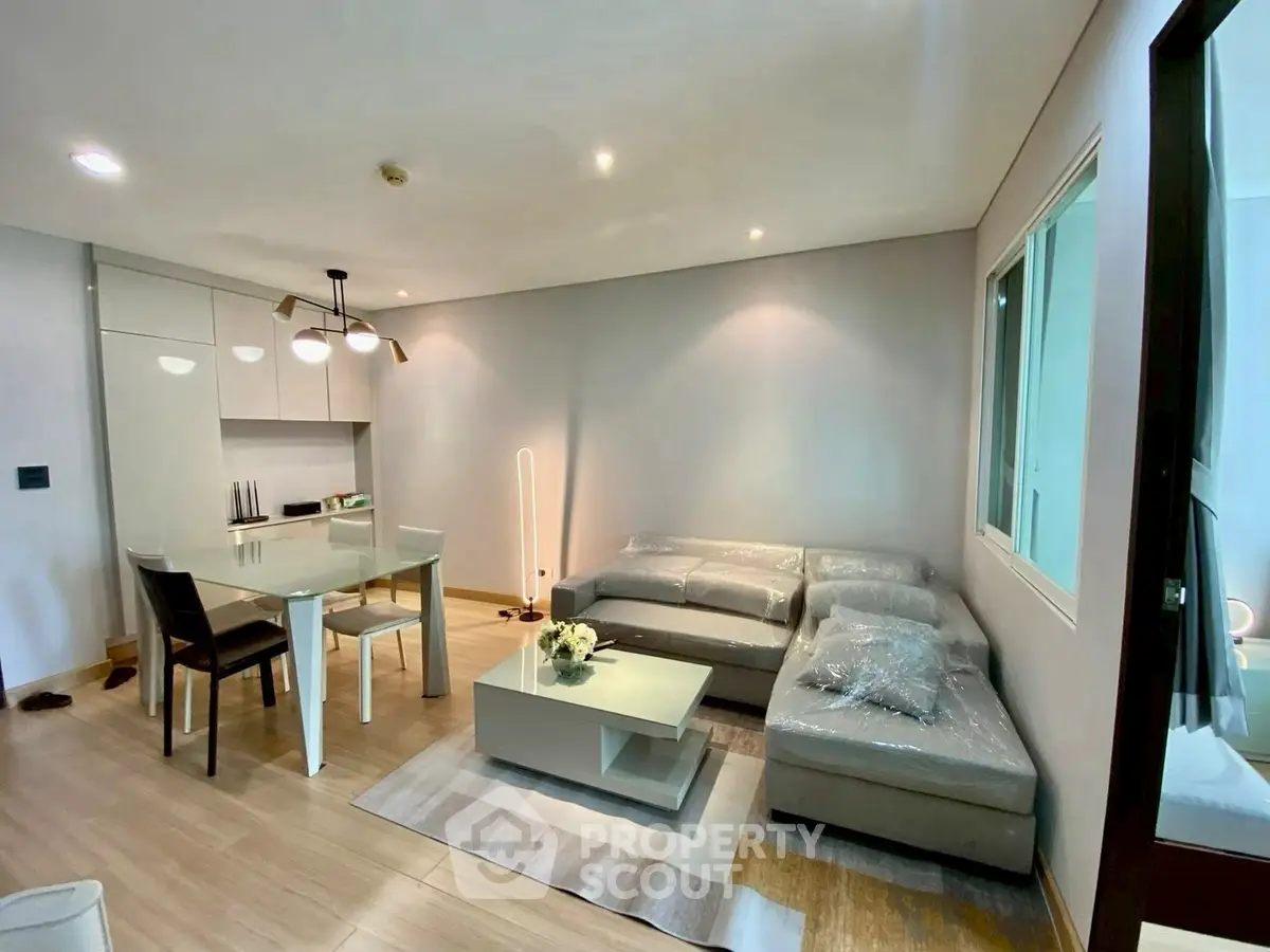 Modern living room with cozy sectional sofa and dining area