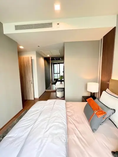 Modern bedroom with stylish decor and cozy ambiance in a luxury apartment.