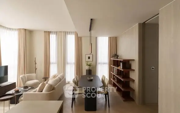 Elegant living room with modern dining area and natural light