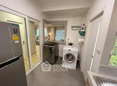 Modern laundry room with washing machine and dryer in sleek apartment.