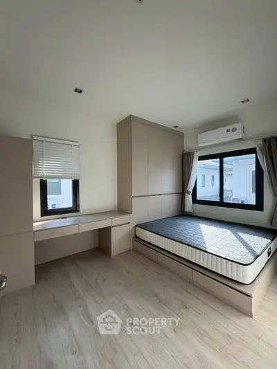 Modern minimalist bedroom with built-in storage and natural light