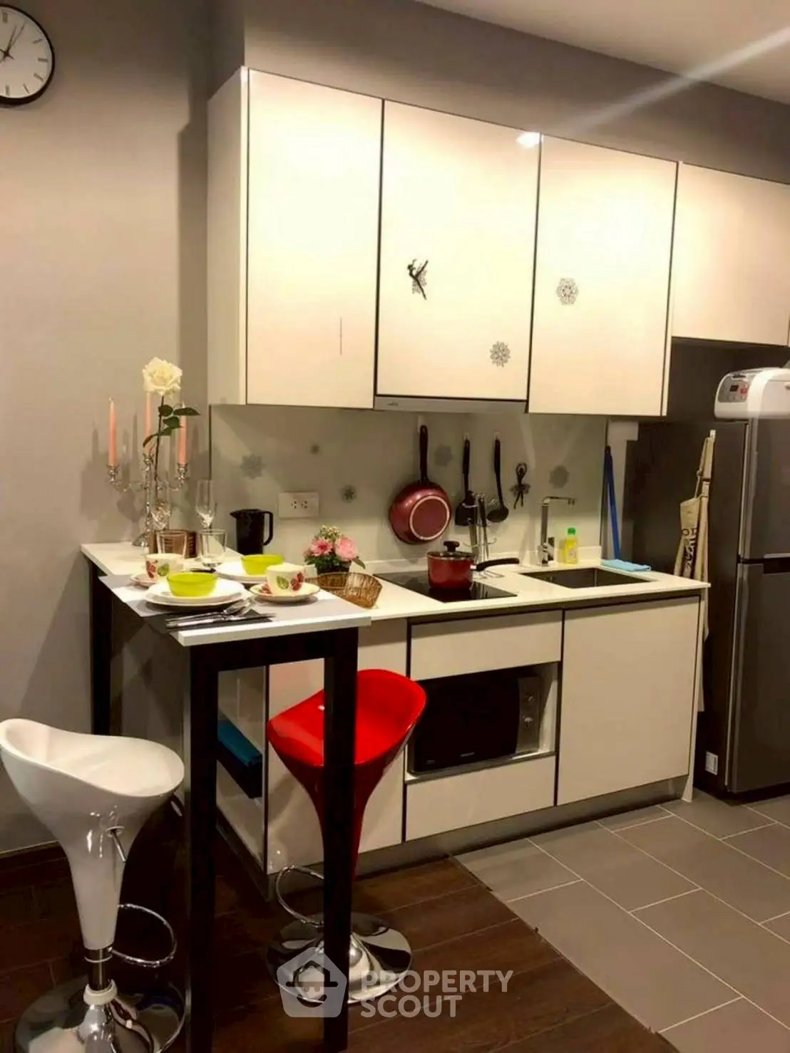 Modern kitchen with sleek cabinets and breakfast bar in cozy apartment.