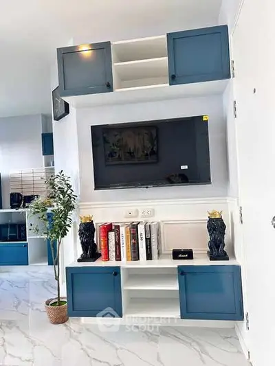 Modern living room with stylish blue cabinetry and sleek TV setup
