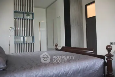 Spacious bedroom with elegant wooden bed and modern decor