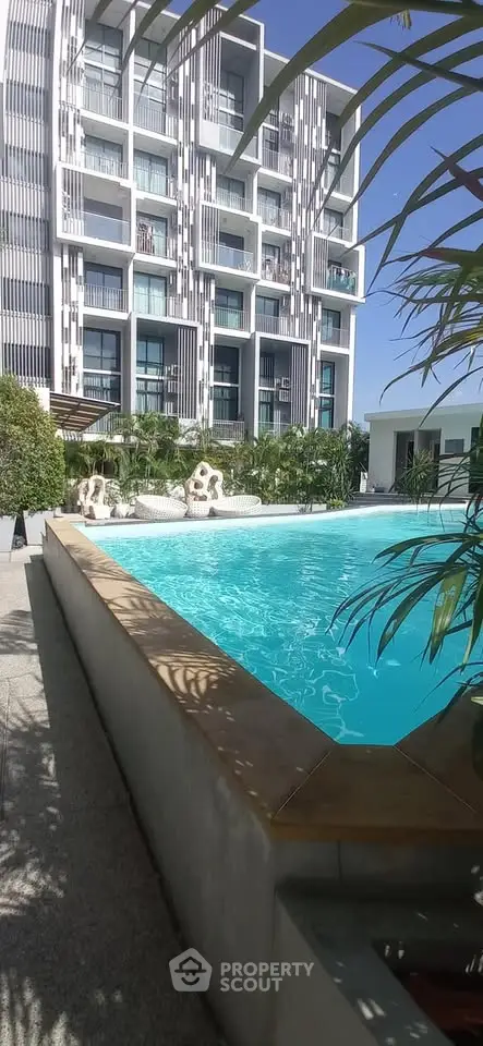 Luxurious apartment building with stunning pool and lush greenery