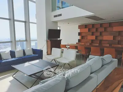 Luxurious modern living room with stunning city view, featuring stylish furniture and floor-to-ceiling windows.