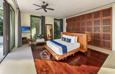 Luxurious modern bedroom with wooden flooring and large windows