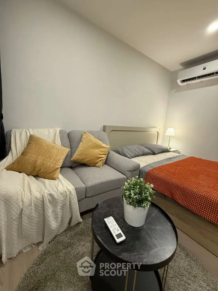 Cozy bedroom with modern sofa and stylish decor