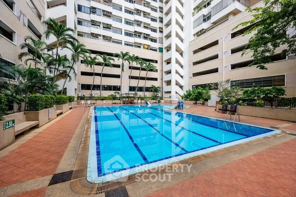 Luxurious apartment complex with a stunning outdoor pool and lush greenery, perfect for relaxation and leisure.
