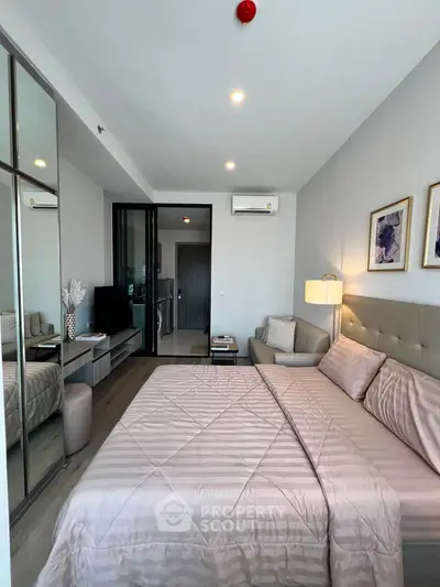Modern bedroom with stylish decor and mirrored wardrobe in a contemporary apartment.