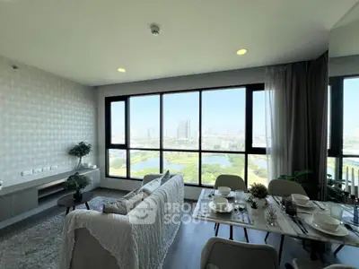 Spacious living room with panoramic city view and elegant dining setup