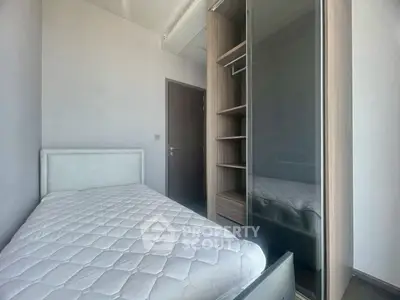 Cozy bedroom with modern wardrobe and comfortable bed in a stylish apartment.