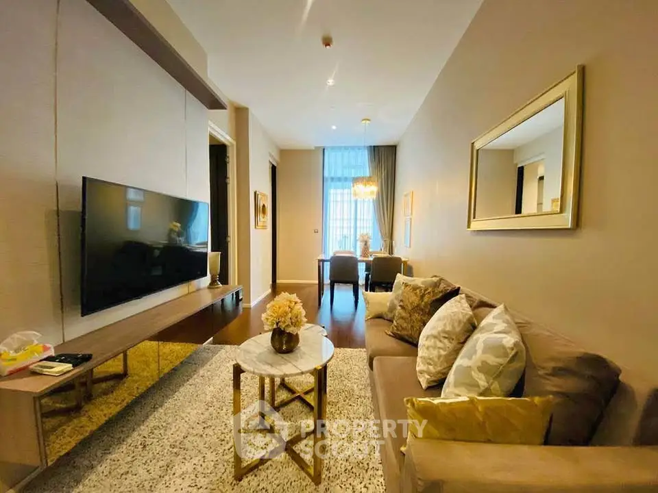 Elegant living room with modern decor and large TV, perfect for relaxation and entertainment.