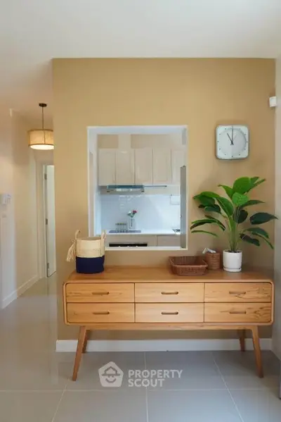 Stylish modern kitchen with open layout and elegant wooden furniture, perfect for contemporary living.
