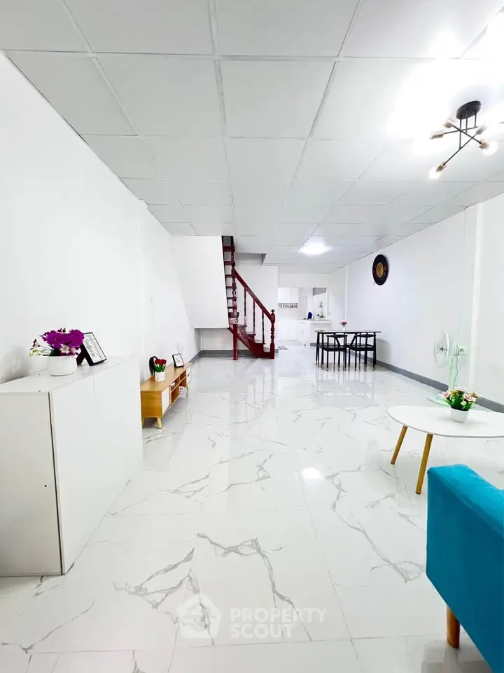 Spacious modern living room with elegant white tiles and stylish decor