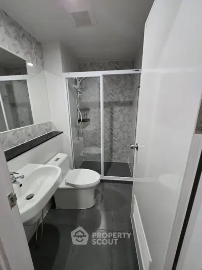Modern bathroom with sleek shower and contemporary fixtures in a stylish apartment.
