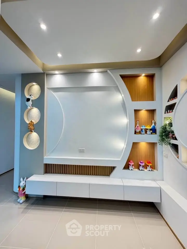 Modern living room with stylish wall decor and recessed lighting