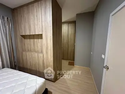 Modern bedroom with sleek wooden wardrobe and minimalist design