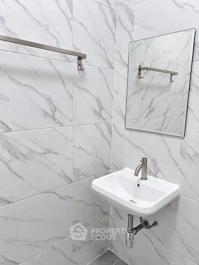 Modern bathroom with marble tiles and sleek sink design
