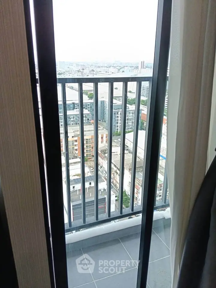 Stunning city view from a high-rise balcony with sleek railing design.