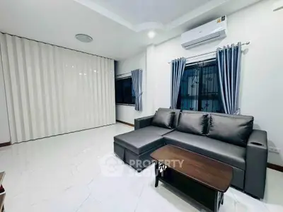 Modern living room with sleek sofa and air conditioning, perfect for relaxation.