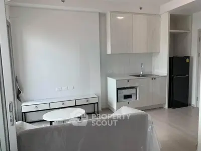 Modern apartment interior with compact kitchen and cozy living area