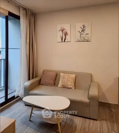 Modern living room with stylish sofa and balcony view in a cozy apartment.