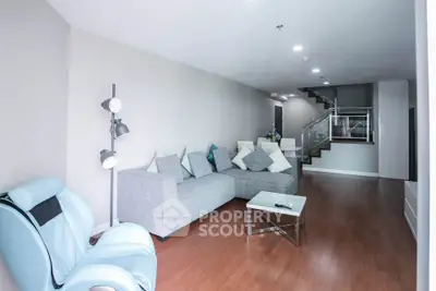 Spacious modern living room with stylish furniture and wooden flooring