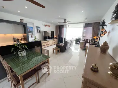 Spacious modern living room with open layout and elegant decor, featuring a dining area and large windows.