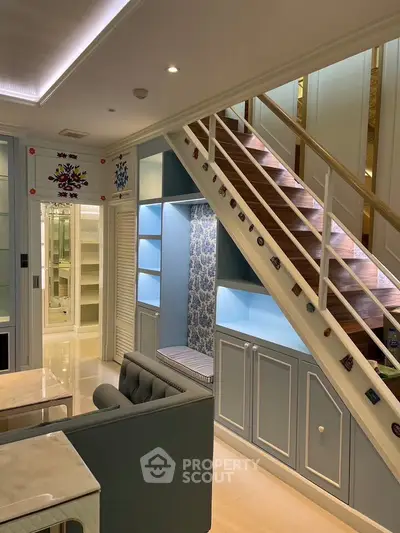 Charming duplex living room with stylish staircase and cozy seating area
