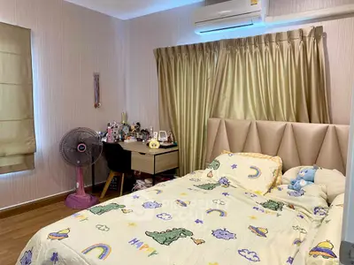 Cozy bedroom with playful dinosaur-themed bedding and air conditioning