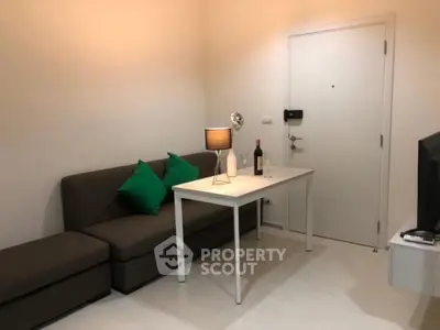 Cozy living room with modern sofa and stylish decor in a compact apartment.