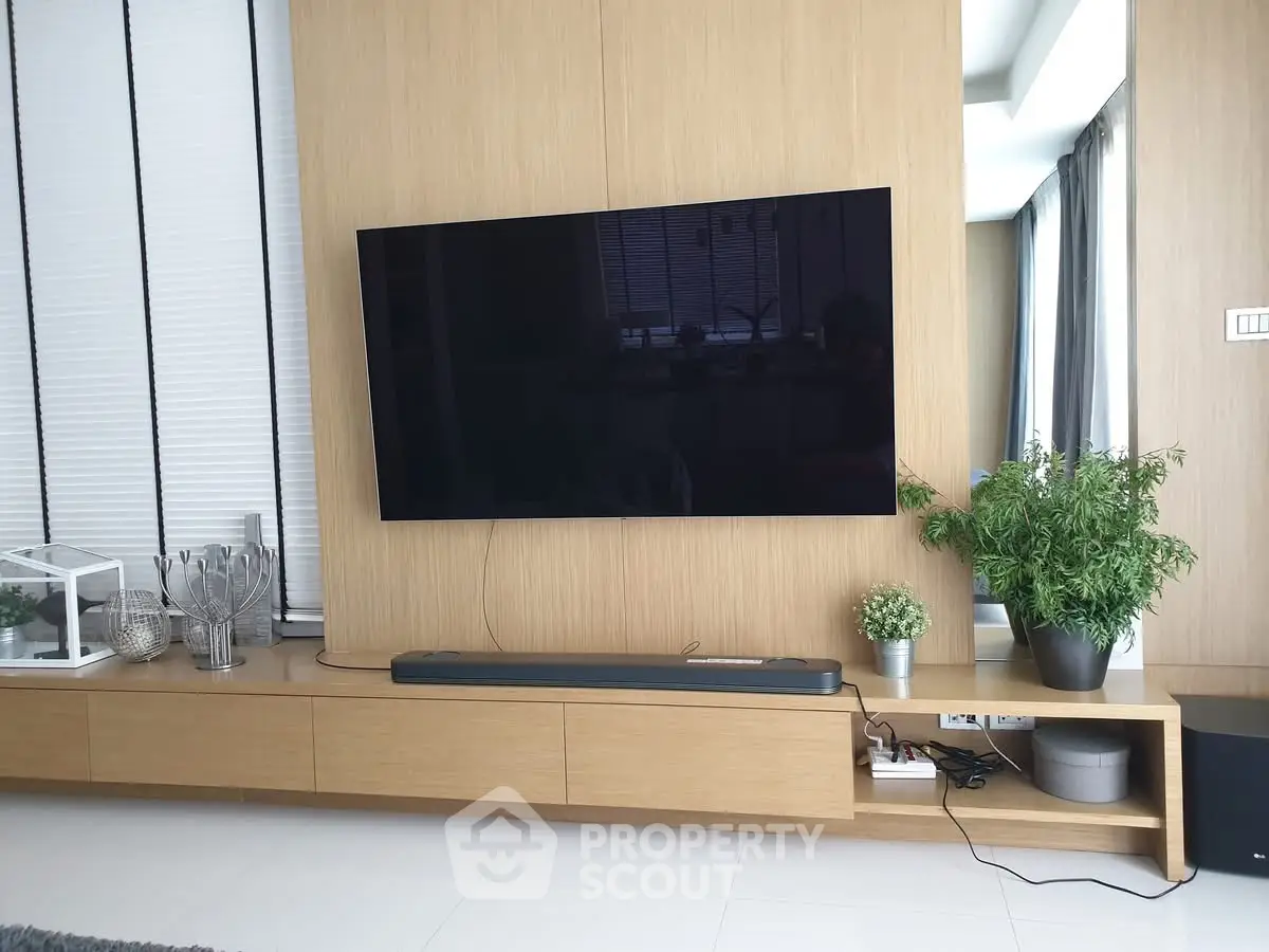 Modern living room with sleek wall-mounted TV and stylish decor