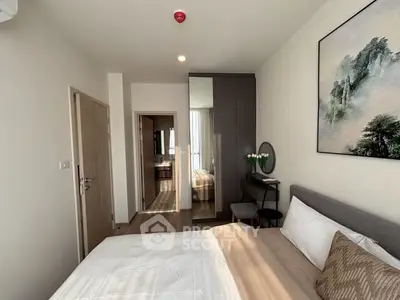 Modern bedroom with stylish decor and ensuite bathroom in a contemporary apartment.