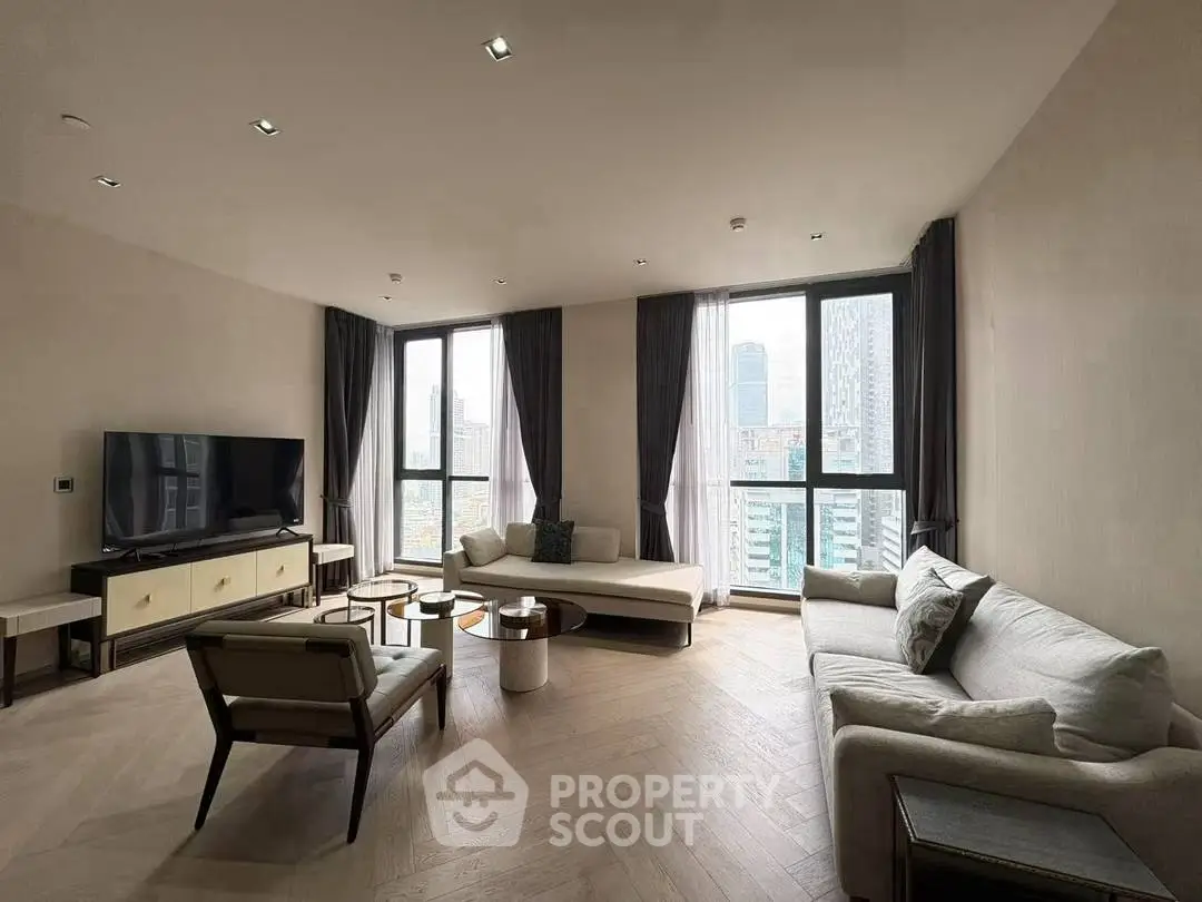 Spacious modern living room with large windows and city view, featuring elegant furniture and stylish decor.