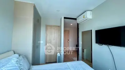 Modern bedroom with air conditioning and wall-mounted TV in a stylish apartment.