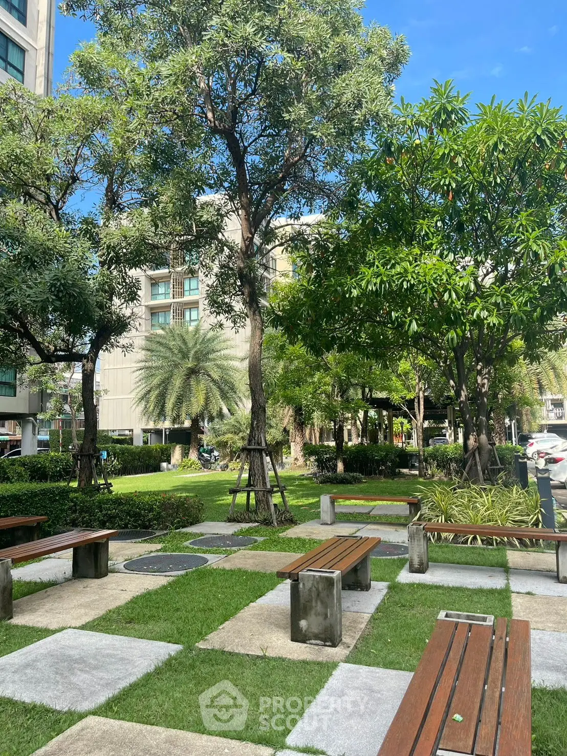 Lush garden area with benches in a modern residential complex