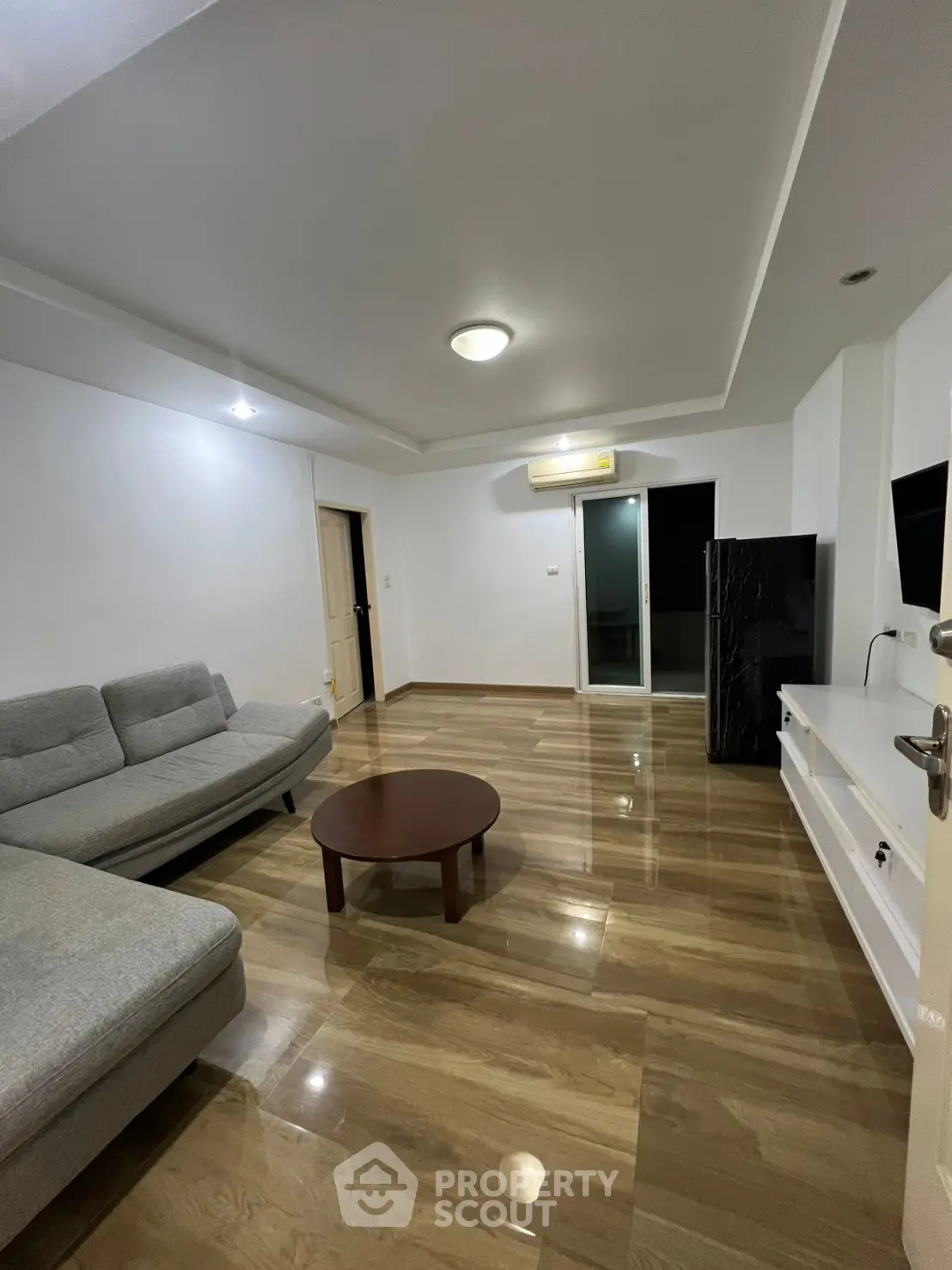 Spacious living room with modern sofa and sleek wooden flooring